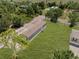 Aerial shot showcases home with a large yard and mature trees at 8414 Sweden Blvd, Punta Gorda, FL 33982
