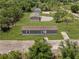 Aerial view of a single-story home with a well-maintained lawn surrounded by lush trees at 8414 Sweden Blvd, Punta Gorda, FL 33982