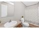 A neutral bathroom with a toilet, sink, and shower with a decorative shower curtain at 8414 Sweden Blvd, Punta Gorda, FL 33982