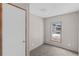 An empty bedroom with neutral-colored walls and carpet and a window at 8414 Sweden Blvd, Punta Gorda, FL 33982
