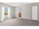 A bedroom with neutral-colored walls and carpet with an ensuite bathroom at 8414 Sweden Blvd, Punta Gorda, FL 33982