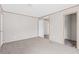 A bedroom with neutral-colored walls and carpet with an open closet at 8414 Sweden Blvd, Punta Gorda, FL 33982