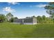 Exterior view of home with well-maintained lawn and mature trees at 8414 Sweden Blvd, Punta Gorda, FL 33982