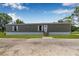 Charming single-story home with a well-maintained lawn and inviting front entrance with a small set of stairs at 8414 Sweden Blvd, Punta Gorda, FL 33982