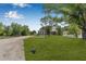 Exterior view of charming homes amidst lush greenery and mature trees at 8414 Sweden Blvd, Punta Gorda, FL 33982
