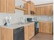 The kitchen is equipped with light wood cabinets and black appliances, perfect for any home chef at 8414 Sweden Blvd, Punta Gorda, FL 33982