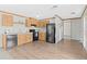 The kitchen features light wood cabinets and black appliances for a sleek, modern look at 8414 Sweden Blvd, Punta Gorda, FL 33982