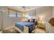 Cozy bedroom boasts natural light, ceiling fan, and neutral paint palette at 9034 Midnight Pass Rd # 6, Sarasota, FL 34242
