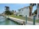 Exterior view of a two-story home with a deck, backyard, and boat dock at 9034 Midnight Pass Rd # 6, Sarasota, FL 34242