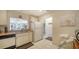 Well-lit kitchen with appliances, a breakfast bar, and a passthrough to the living area at 9034 Midnight Pass Rd # 6, Sarasota, FL 34242
