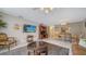 Cozy living area with a flat-screen TV, comfortable seating, and a view into the dining area at 9034 Midnight Pass Rd # 6, Sarasota, FL 34242