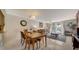 Open-concept layout with a dining area and living room, leading to a bright balcony with sheer curtains at 9034 Midnight Pass Rd # 6, Sarasota, FL 34242