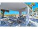 Open-air pavilion with wooden picnic tables, offering a relaxing view of the beach at 9034 Midnight Pass Rd # 6, Sarasota, FL 34242