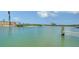 Serene waterfront view with docks extending into the turquoise water at 9034 Midnight Pass Rd # 6, Sarasota, FL 34242