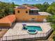 Drone view of the home, highlighting its backyard pool, patio, solar panels, and the lush surrounding landscape at 95 Vic Edwards Rd, Sarasota, FL 34240