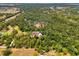 Breathtaking aerial view of a house with a pool, nestled in a vast forest landscape at 95 Vic Edwards Rd, Sarasota, FL 34240