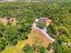 Aerial view of a home surrounded by lush greenery, showcasing its private and expansive lot at 95 Vic Edwards Rd, Sarasota, FL 34240