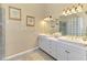Bright bathroom with double sinks, glass block shower, marble countertops, and ample storage at 95 Vic Edwards Rd, Sarasota, FL 34240