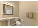 Bright half bath with pedestal sink, decorative mirror, and matching towel set at 95 Vic Edwards Rd, Sarasota, FL 34240