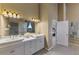 Bright bathroom with double sinks, glass block shower, marble countertops, and ample storage at 95 Vic Edwards Rd, Sarasota, FL 34240