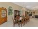 Formal dining room with hardwood table, china cabinet, and lots of natural light from arched windows at 95 Vic Edwards Rd, Sarasota, FL 34240