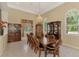Elegant dining room boasting large windows, tile flooring, and classic wooden furniture at 95 Vic Edwards Rd, Sarasota, FL 34240