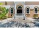Inviting home entrance with decorative lion statues, lush landscaping, and grand architectural details at 95 Vic Edwards Rd, Sarasota, FL 34240
