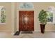 Elegant home entrance with a beautiful wooden door and tile flooring, creating a grand first impression at 95 Vic Edwards Rd, Sarasota, FL 34240