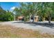A well maintained home with large gravel driveway and a three-car garage at 95 Vic Edwards Rd, Sarasota, FL 34240