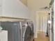 Efficient laundry room featuring modern washer and dryer units and ample storage space for laundry essentials at 95 Vic Edwards Rd, Sarasota, FL 34240