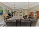 Spacious living room featuring a stone fireplace, tile flooring, and elegant chandelier lighting at 95 Vic Edwards Rd, Sarasota, FL 34240