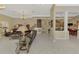 Spacious living room with tiled floors, view of the staircase, and view of dining area at 95 Vic Edwards Rd, Sarasota, FL 34240