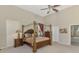 Main bedroom featuring a four-poster bed, ensuite bathroom, and beautiful decorations at 95 Vic Edwards Rd, Sarasota, FL 34240