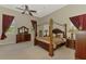 Large main bedroom with a four-poster bed, ensuite bathroom, and and nightstands at 95 Vic Edwards Rd, Sarasota, FL 34240