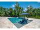 Inviting in-ground pool with a tanning ledge, spa, and comfortable lounge chairs, perfect for relaxing and entertaining at 95 Vic Edwards Rd, Sarasota, FL 34240