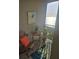 Cozy balcony space featuring a small table, chair, potted plants, and a serene view of the water at 1030 Tidewater Shores Loop # 404, Bradenton, FL 34208