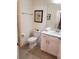 Well-lit bathroom featuring a toilet, vanity with sink, and decorative artwork adding charm to the space at 1030 Tidewater Shores Loop # 404, Bradenton, FL 34208