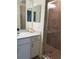 Bathroom featuring a glass shower and white vanity at 1030 Tidewater Shores Loop # 404, Bradenton, FL 34208