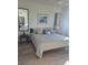 Comfortable bedroom with a well-made bed, decorative pillows, bedside tables, lamps, and a stylish accent mirror at 1030 Tidewater Shores Loop # 404, Bradenton, FL 34208