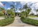 Clubhouse entrance with landscaped walkway offers a welcoming entry to community amenities and activities at 1030 Tidewater Shores Loop # 404, Bradenton, FL 34208