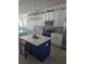 Stylish kitchen showcasing white cabinets, stainless steel appliances, a decorative backsplash, and a navy kitchen island at 1030 Tidewater Shores Loop # 404, Bradenton, FL 34208