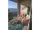Inviting lanai featuring comfortable wicker chairs, a glass table, and a view of the serene water at 1030 Tidewater Shores Loop # 404, Bradenton, FL 34208