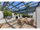 Outdoor kitchen and fireplace beneath pergola with seating area, perfect for entertaining and relaxing outdoors at 1030 Tidewater Shores Loop # 404, Bradenton, FL 34208