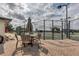 Outdoor tennis courts with table and umbrella offer residents a place to relax and socialize at 1030 Tidewater Shores Loop # 404, Bradenton, FL 34208