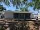 View of the back of the home and screened in porch from the backyard at 1220 12Th W Ave, Palmetto, FL 34221