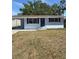 A front exterior view of the house with a nice lawn and awning at 1220 12Th W Ave, Palmetto, FL 34221