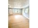 Cozy living room featuring light-colored flooring, a large window, and neutral wall paint at 1220 12Th W Ave, Palmetto, FL 34221