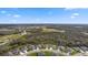 Panoramic aerial view of the neighborhood surrounded by vast green spaces and blue skies at 12715 Wheatgrass Ct, Parrish, FL 34219