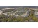 An aerial view of the neighborhood showcasing the lake, streets, and backyard pools at 12715 Wheatgrass Ct, Parrish, FL 34219