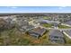 Aerial view showing backyard screened-in pools and homes around the lake at 12715 Wheatgrass Ct, Parrish, FL 34219
